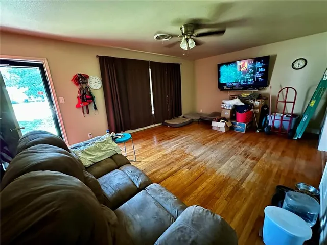 a living room with furniture gym equipment and a flat screen tv