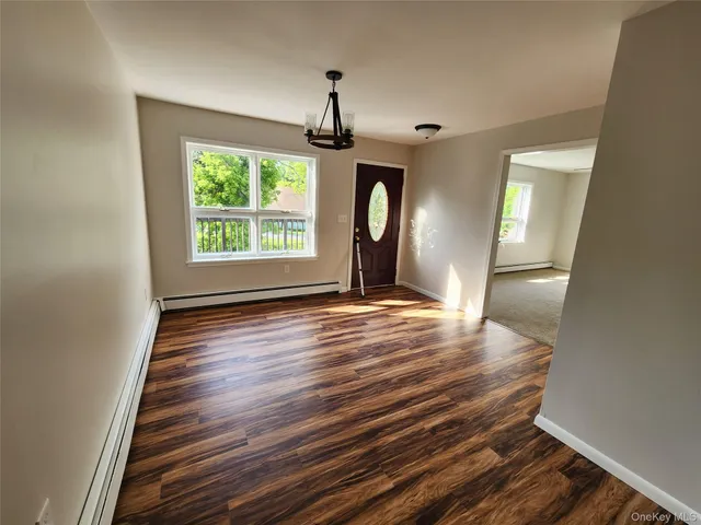 an empty room with windows and ceiling fan