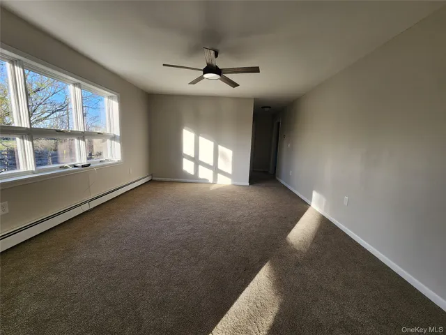 a view of room with window and wooden floor