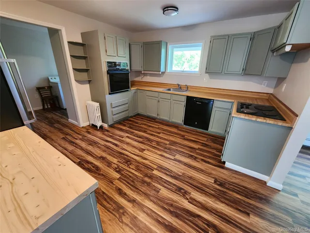a view of a room with wooden floor