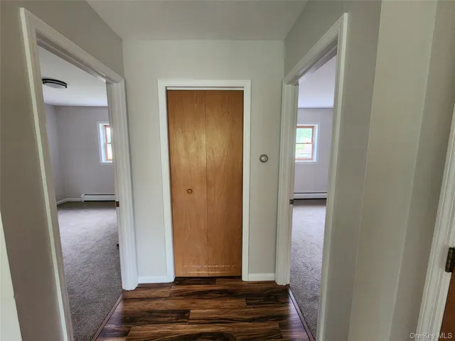 an empty room with closet and mirror