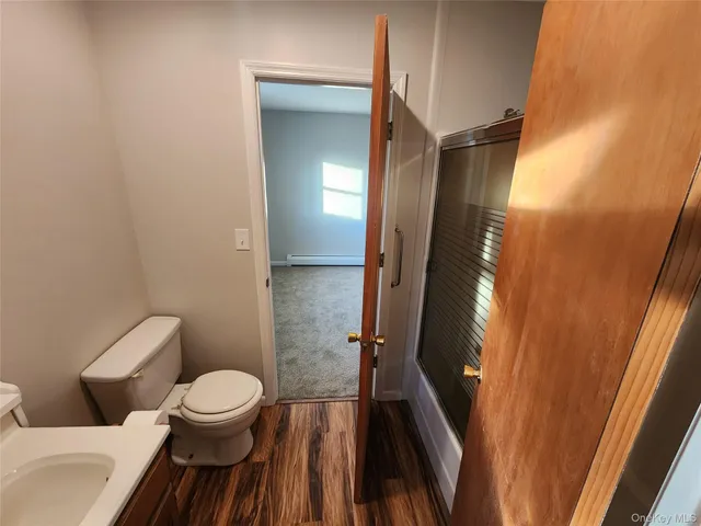 a bathroom with a toilet sink and mirror