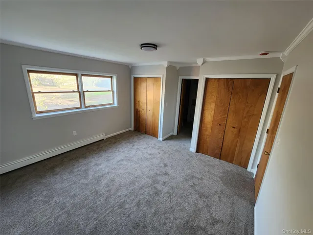 a bathroom with a double vanity sink and mirror with bathtub