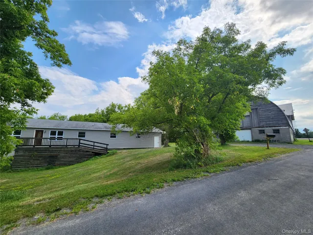 a view of a yard with large trees