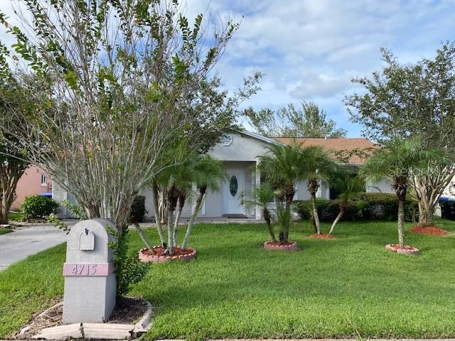 4715 Glenview Lane Orlando, FL 32821 - Photo 1 of 1 a front view of a house with garden and a tree