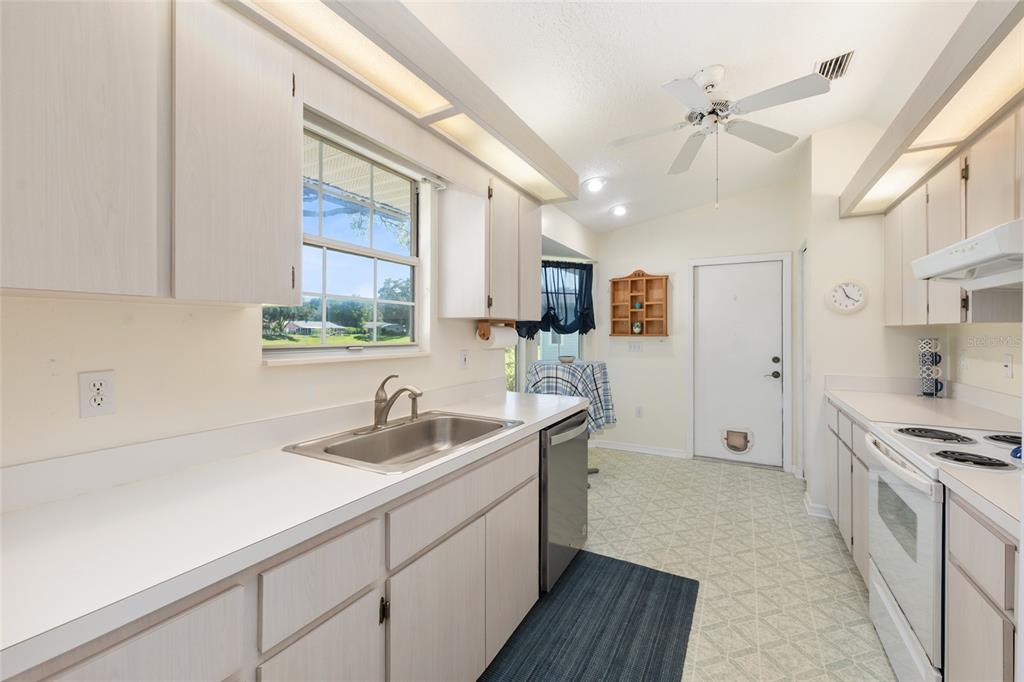8038 Southwest 108th Loop Ocala, FL 34481 - Photo 12 of 48 a kitchen with stainless steel appliances granite countertop a sink stove and refrigerator
