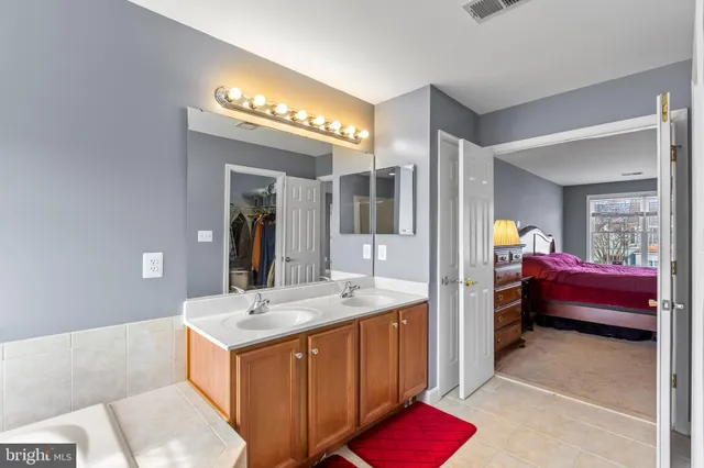 a en suite bathroom with a tub and a mirror