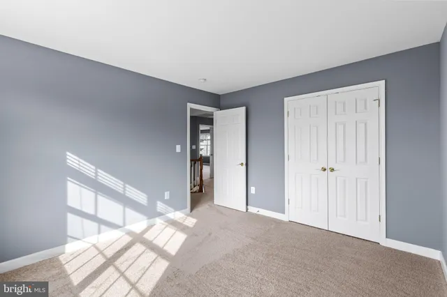 a view of a big room with windows and entryway