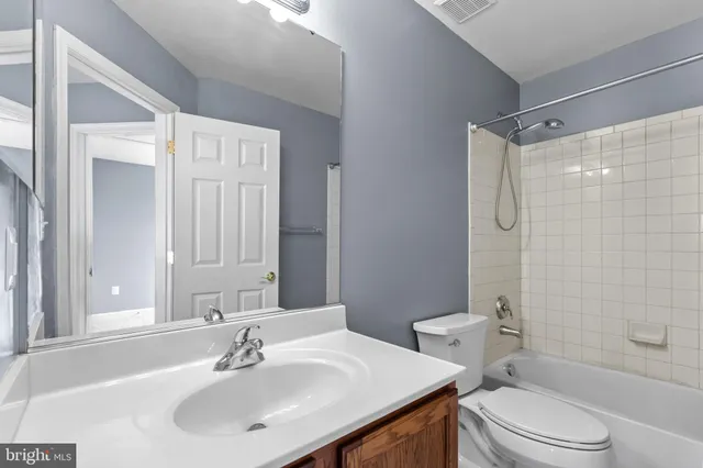 a bathroom with a sink toilet vanity and shower