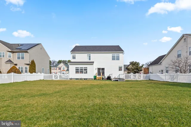 a view of a house with a big yard and a large tree