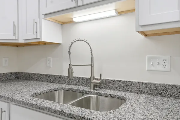 a stove top oven sitting inside of a kitchen