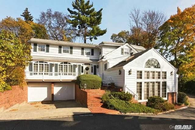 66 Shore Road Manhasset, NY 11030 - Photo 1 of 1 a front view of a house with a garden