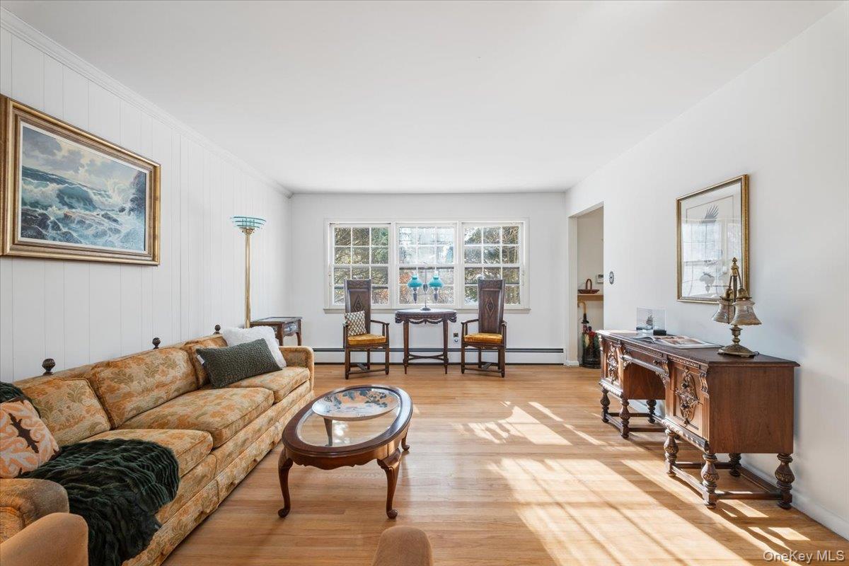 496 Granite Springs Road Yorktown Heights, NY 10598 - Photo 12 of 43 a living room with furniture and a flat screen tv with wooden floor