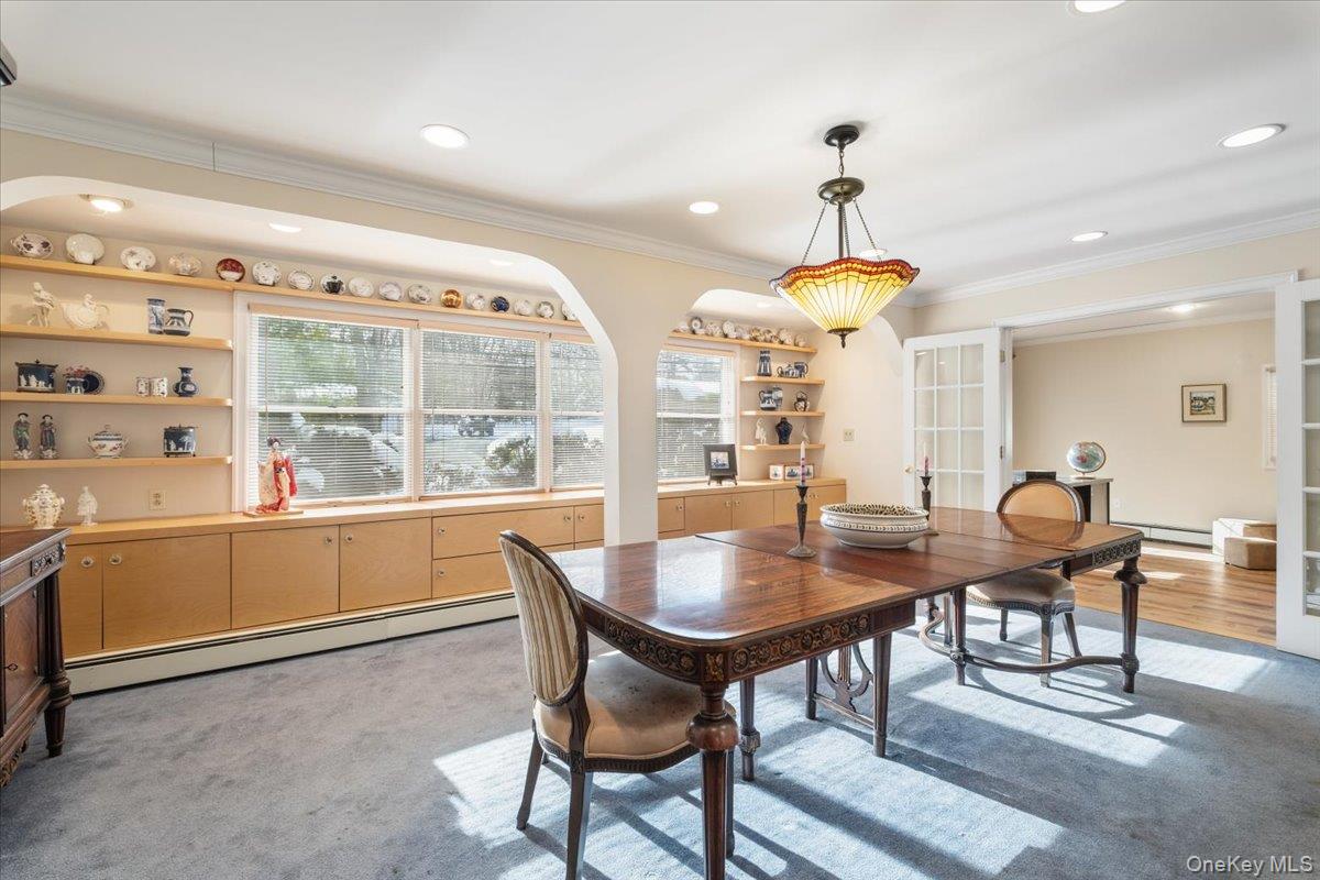 496 Granite Springs Road Yorktown Heights, NY 10598 - Photo 17 of 43 a dining room with furniture a chandelier and wooden floor