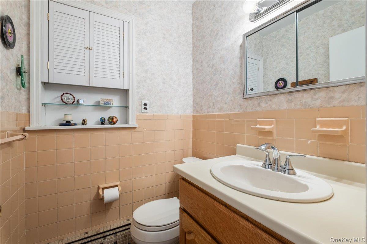 496 Granite Springs Road Yorktown Heights, NY 10598 - Photo 22 of 43 a bathroom with a sink a toilet and a mirror