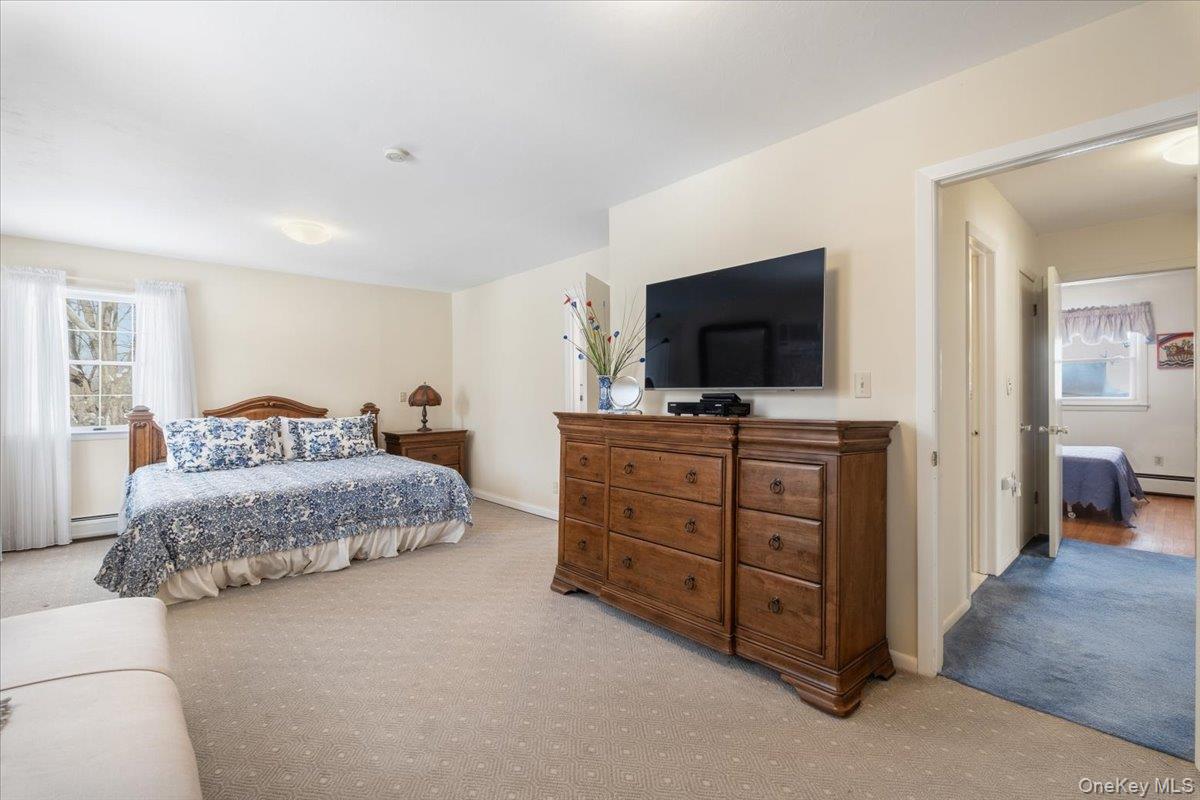 496 Granite Springs Road Yorktown Heights, NY 10598 - Photo 24 of 43 a bedroom with a bed and a flat screen tv