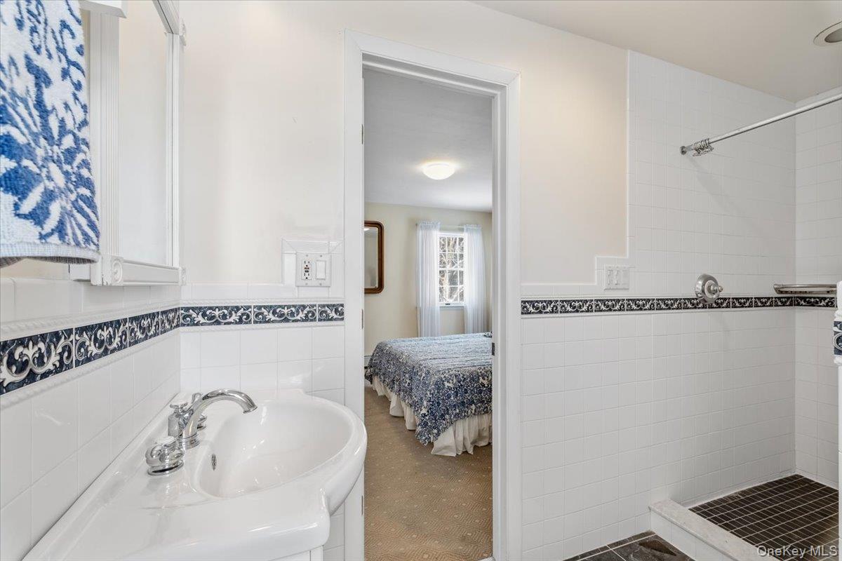 496 Granite Springs Road Yorktown Heights, NY 10598 - Photo 27 of 43 a bathroom with a tub sink and mirror