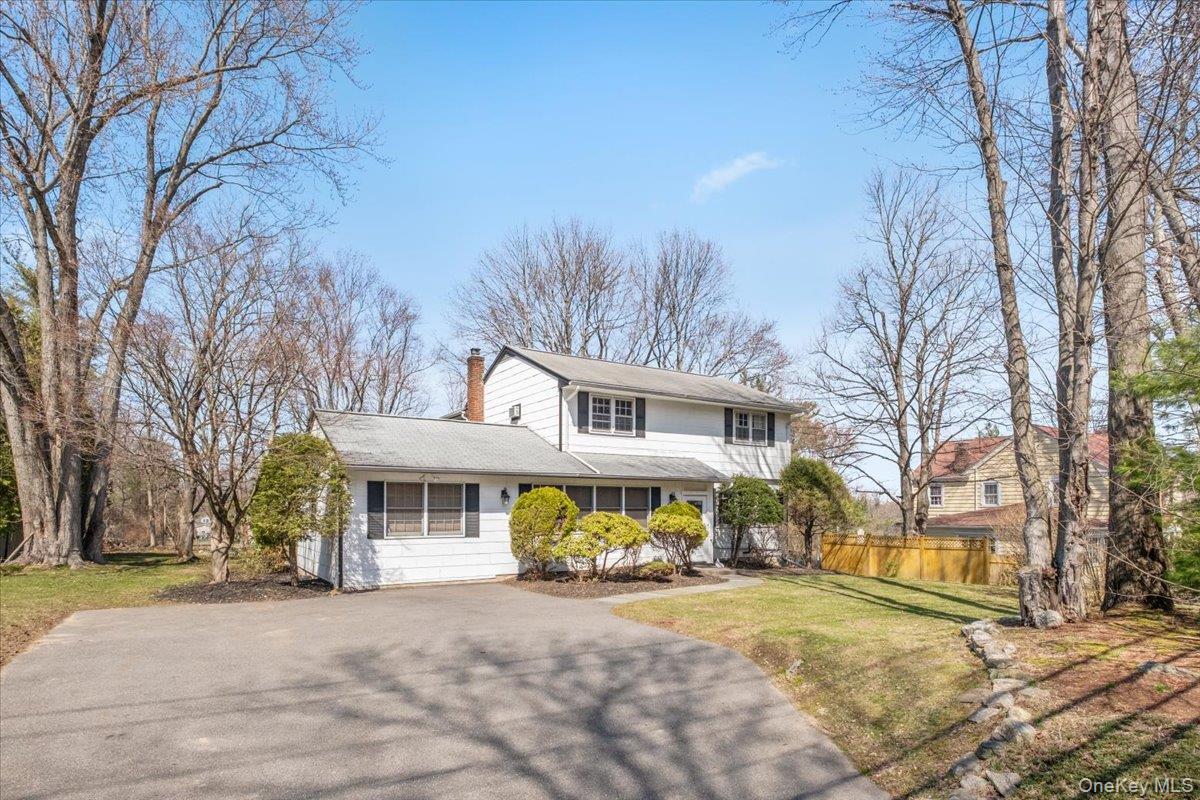 496 Granite Springs Road Yorktown Heights, NY 10598 - Photo 7 of 43 a front view of a house with a yard and garage