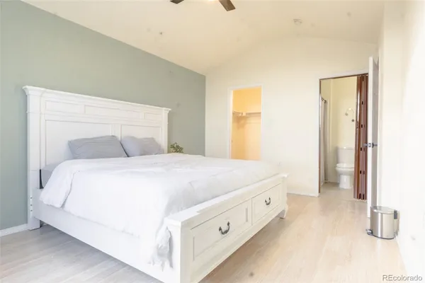 a bedroom with a bed and a night stand