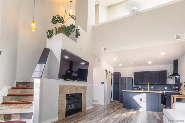 a living room with furniture a fireplace and a flat screen tv
