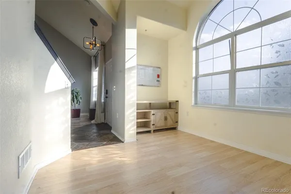 en empty room with a fireplace and windows