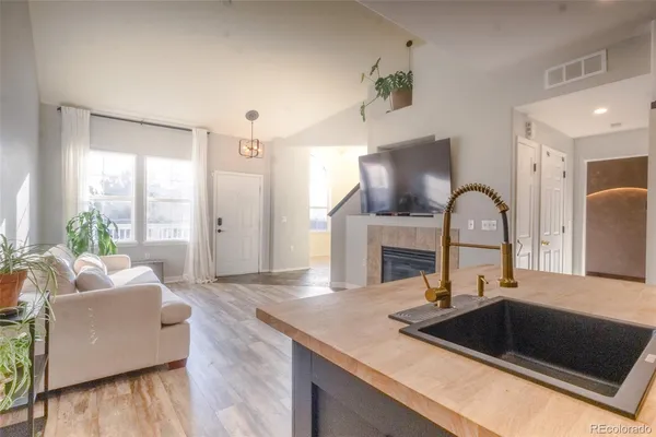 a kitchen with a sink cabinets and a fireplace