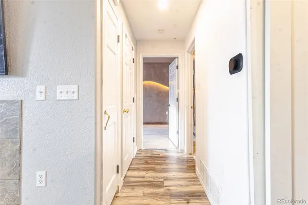 a view of a hallway with wooden floor