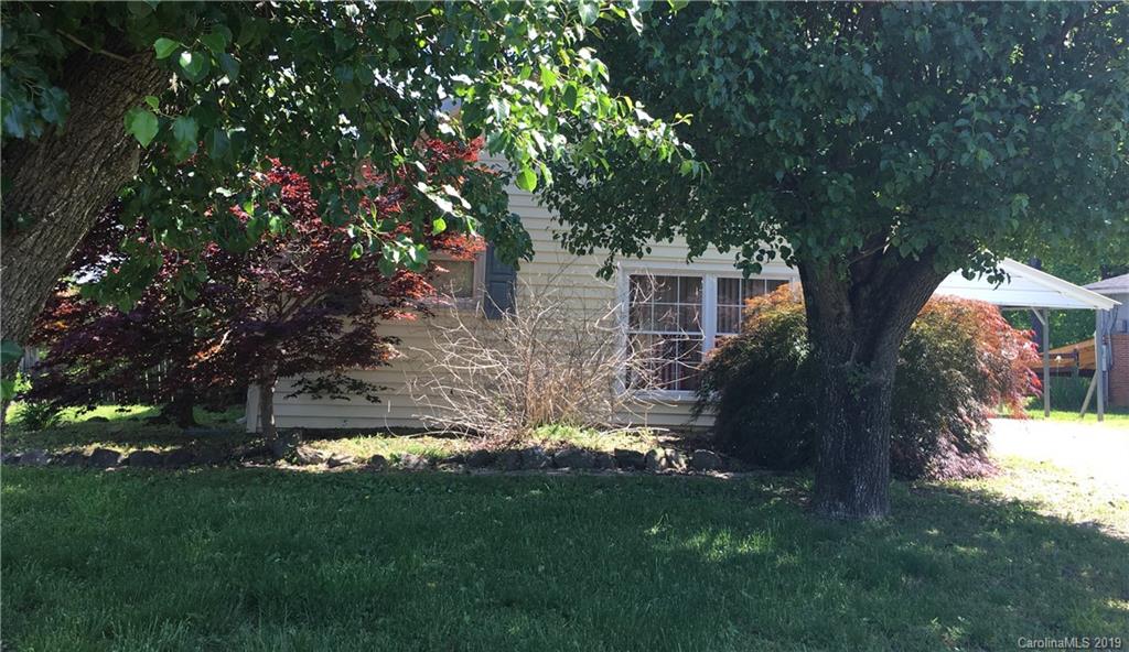 a view of house with backyard