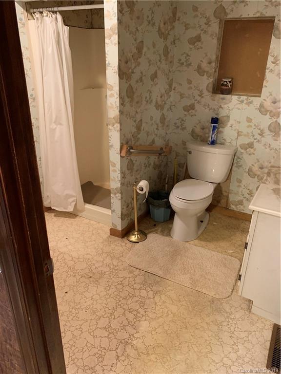 4950 Woodleaf Road Salisbury, NC 28147 - Photo 4 of 10 a bathroom with a toilet and a shower
