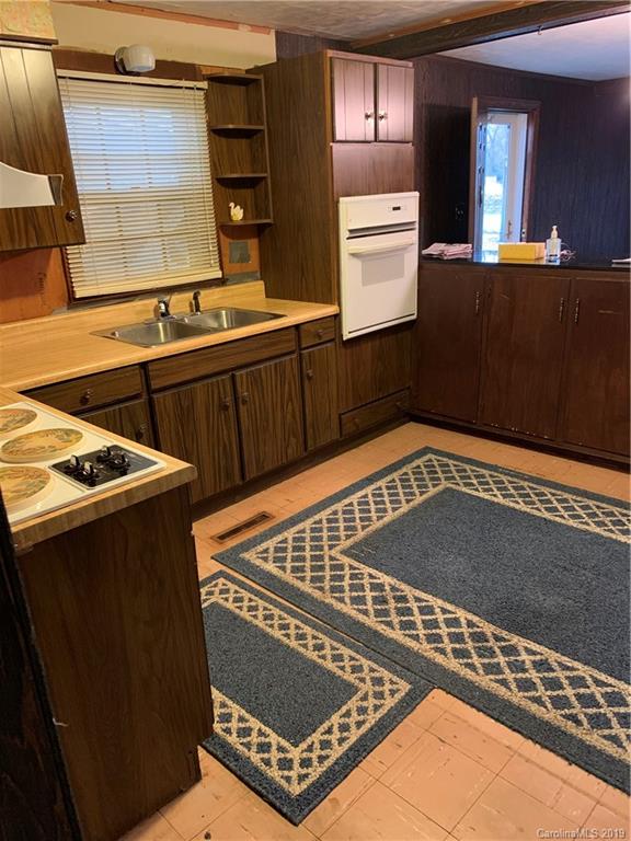 4950 Woodleaf Road Salisbury, NC 28147 - Photo 9 of 10 a view of a kitchen with stainless steel appliances granite countertop a stove a sink and a microwave