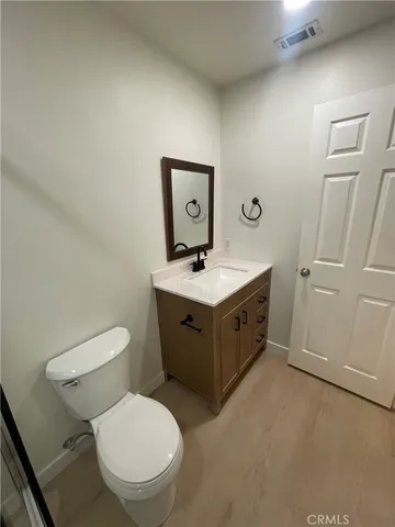 a spacious bathroom with a toilet sink and mirror