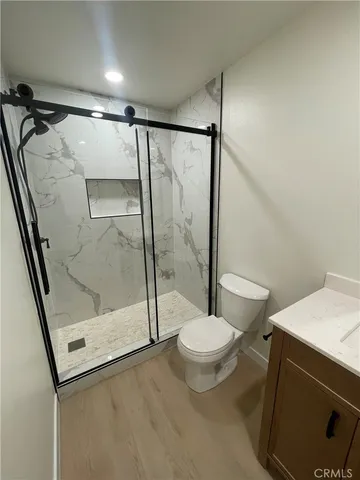 a bathroom with a shower a toilet and a sink