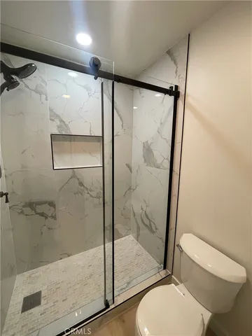a bathroom with a shower and toilet
