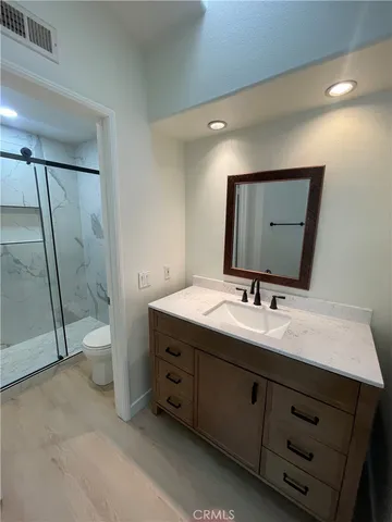 a spacious bathroom with a double vanity sink and mirror