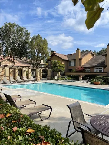an outdoor space with swimming pool and furniture