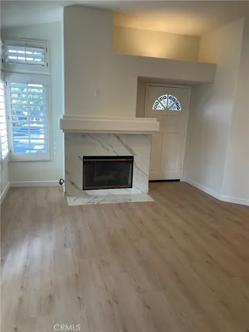 a view of empty room with a fireplace
