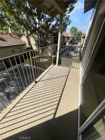 a view of balcony with wooden floor and fence