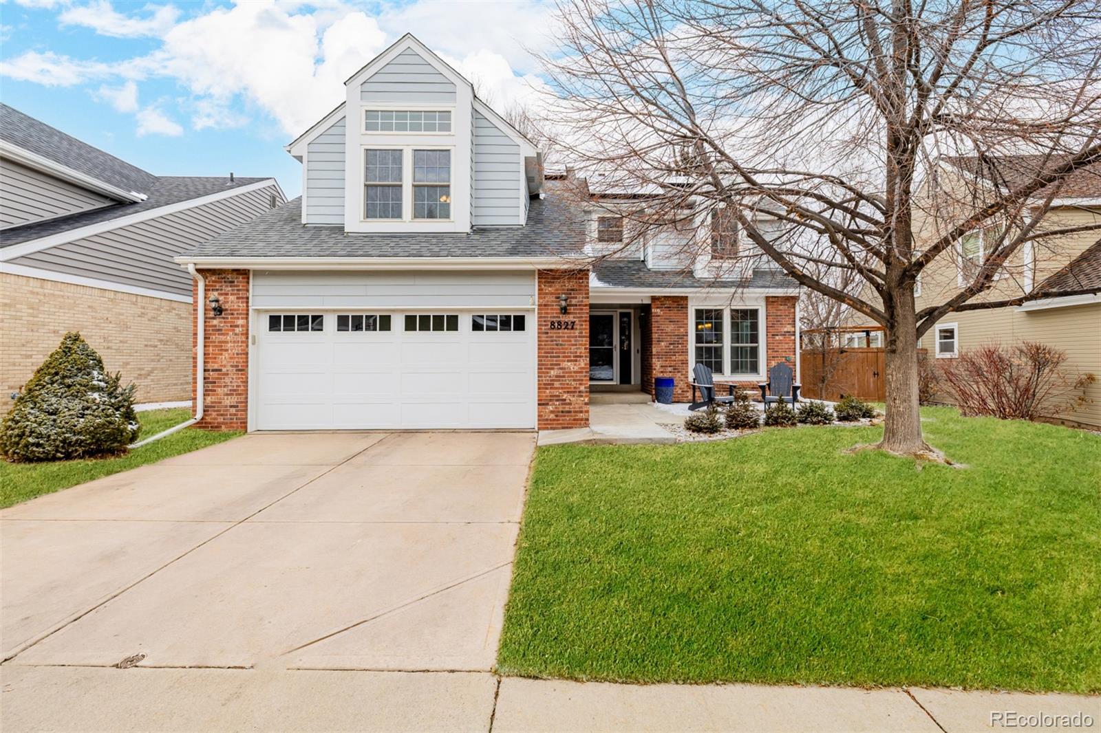 8827 South Cactus Flower Way Highlands Ranch, CO 80126 - Photo 1 of 49 a front view of a building with garden