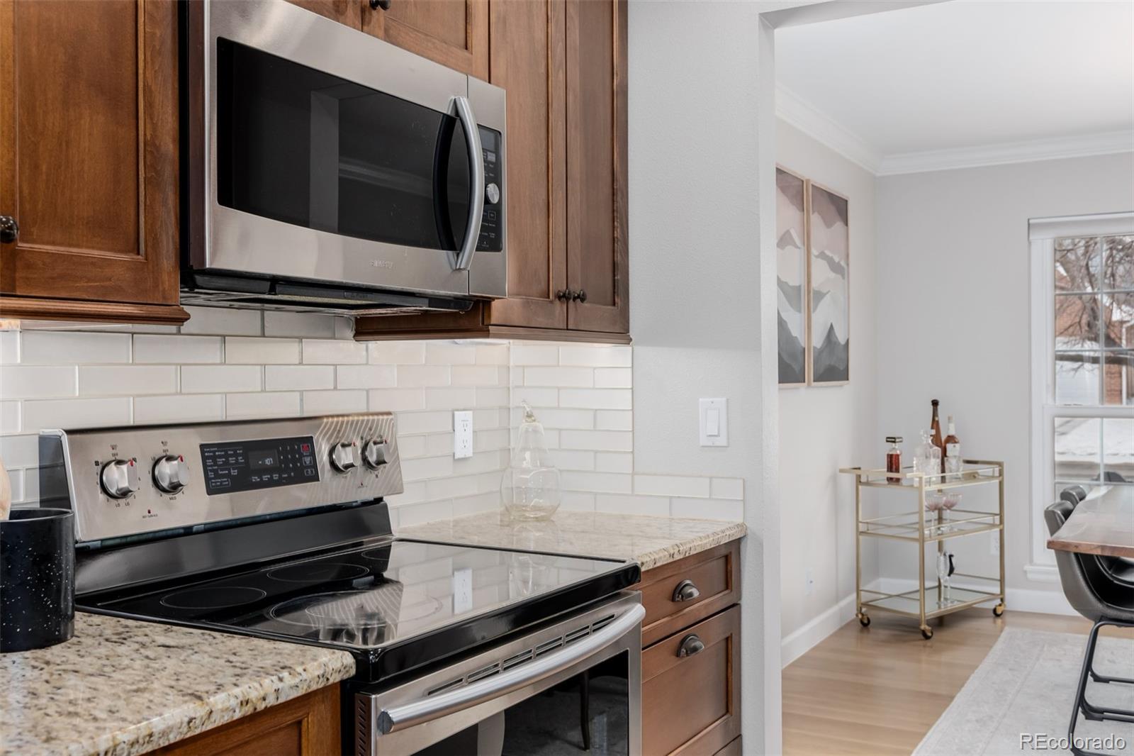 8827 South Cactus Flower Way Highlands Ranch, CO 80126 - Photo 20 of 49 a kitchen with a stove and a microwave