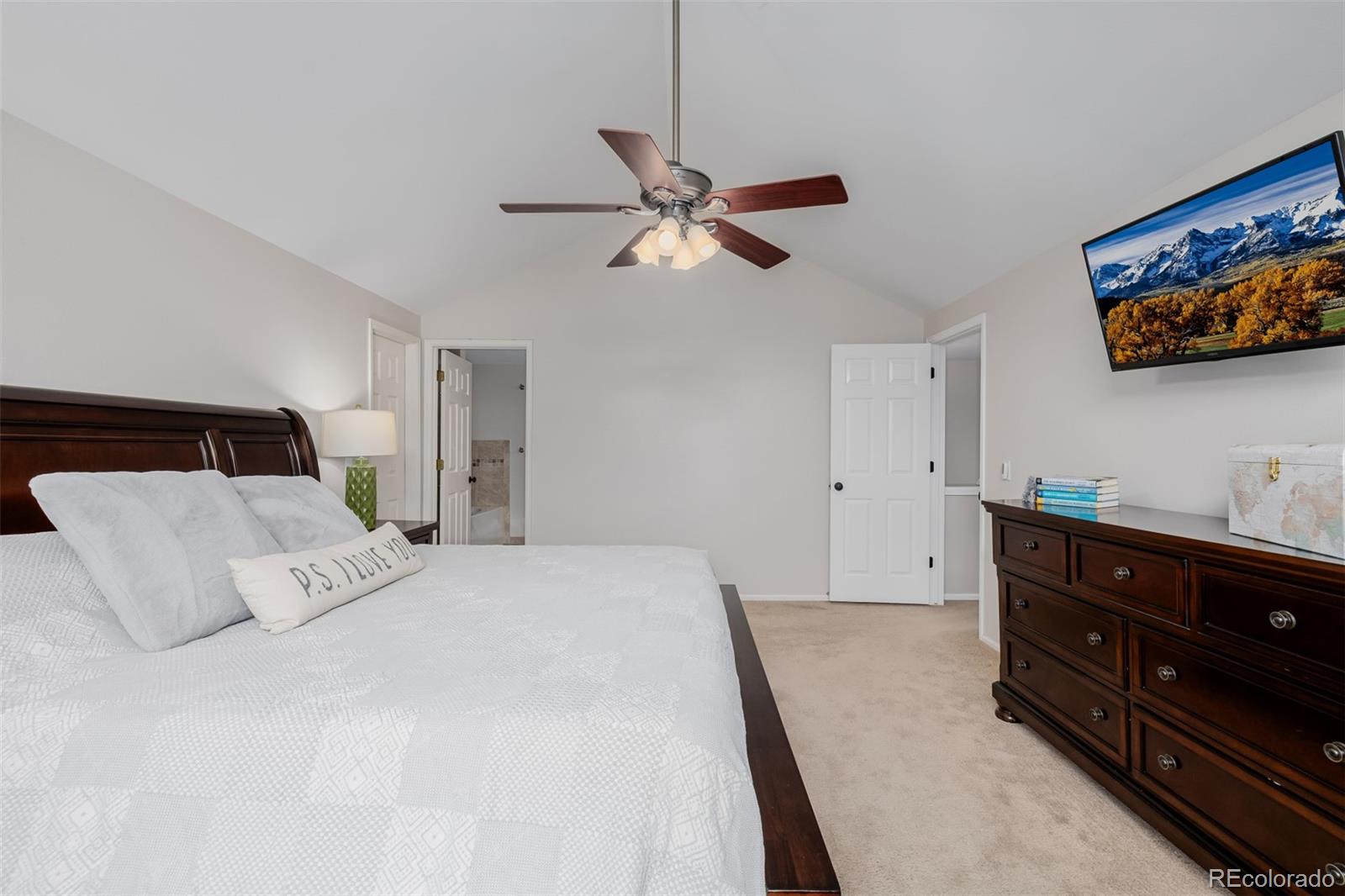 8827 South Cactus Flower Way Highlands Ranch, CO 80126 - Photo 23 of 49 a bedroom with a bed and a flat screen tv