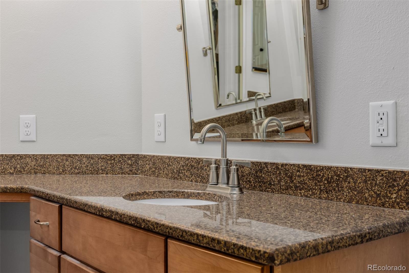 8827 South Cactus Flower Way Highlands Ranch, CO 80126 - Photo 27 of 49 a bathroom with sink and mirror