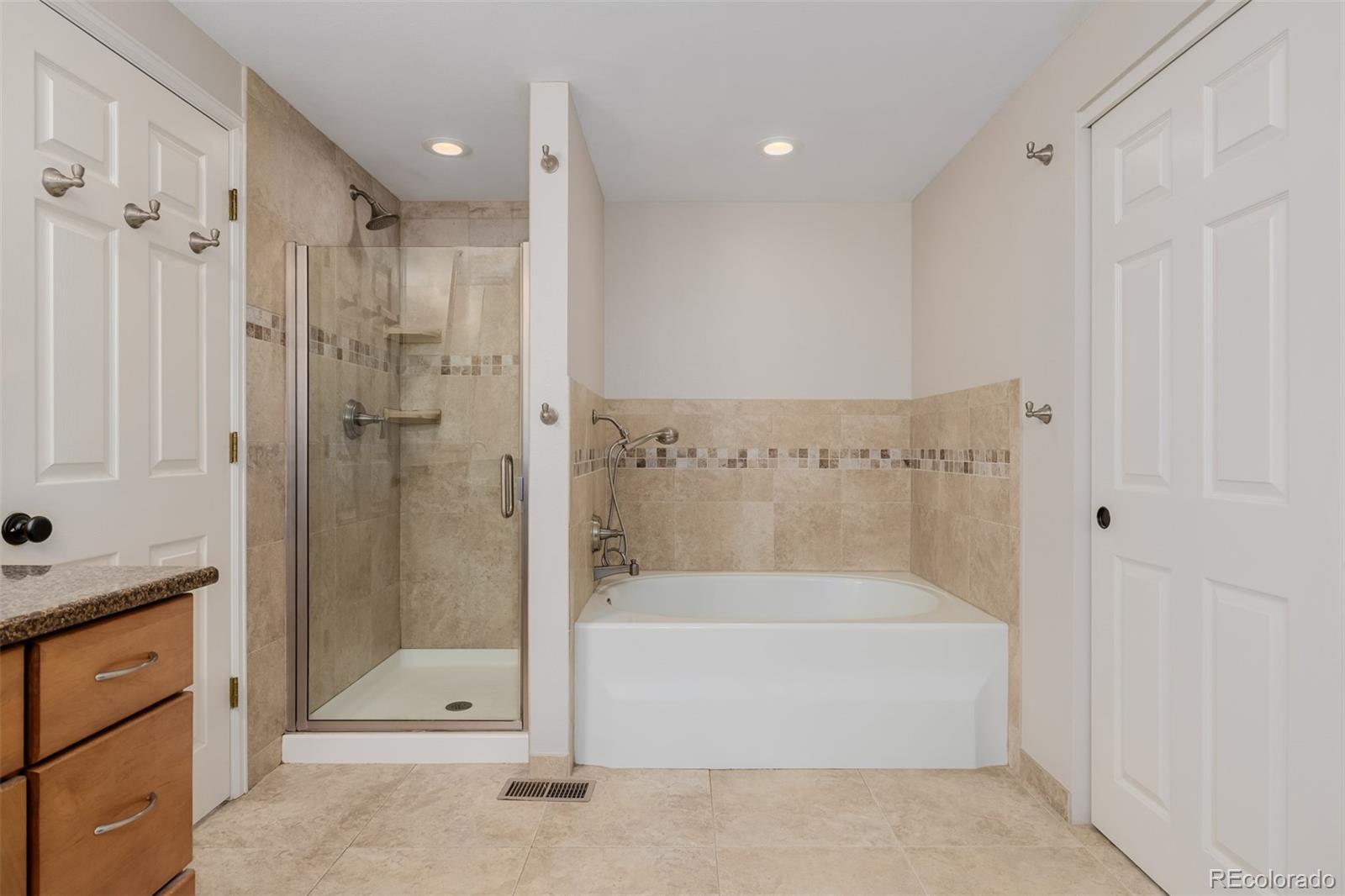 8827 South Cactus Flower Way Highlands Ranch, CO 80126 - Photo 28 of 49 a bathroom with a bathtub and a shower