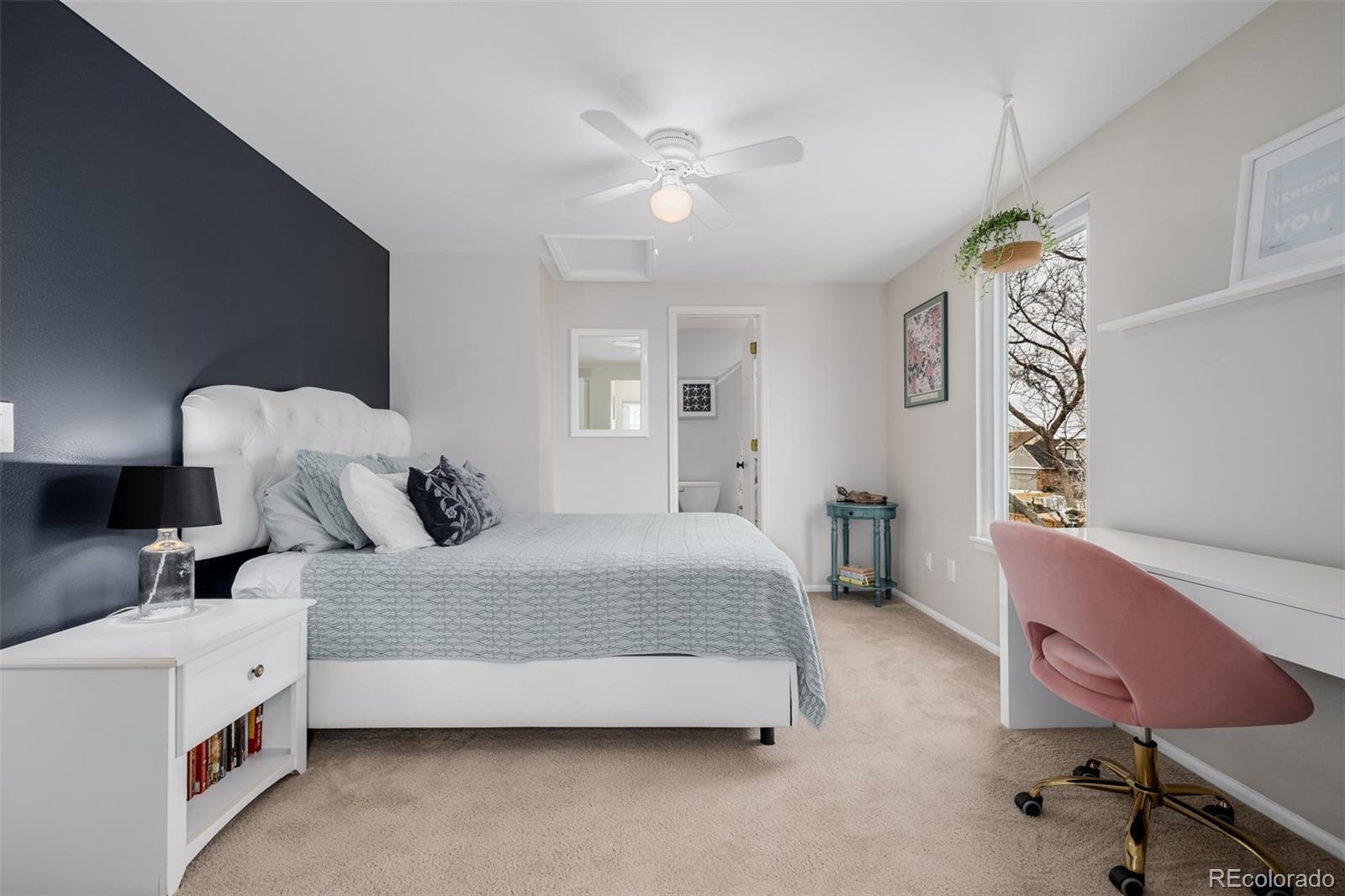 8827 South Cactus Flower Way Highlands Ranch, CO 80126 - Photo 29 of 49 a bedroom with a bed and a chandelier