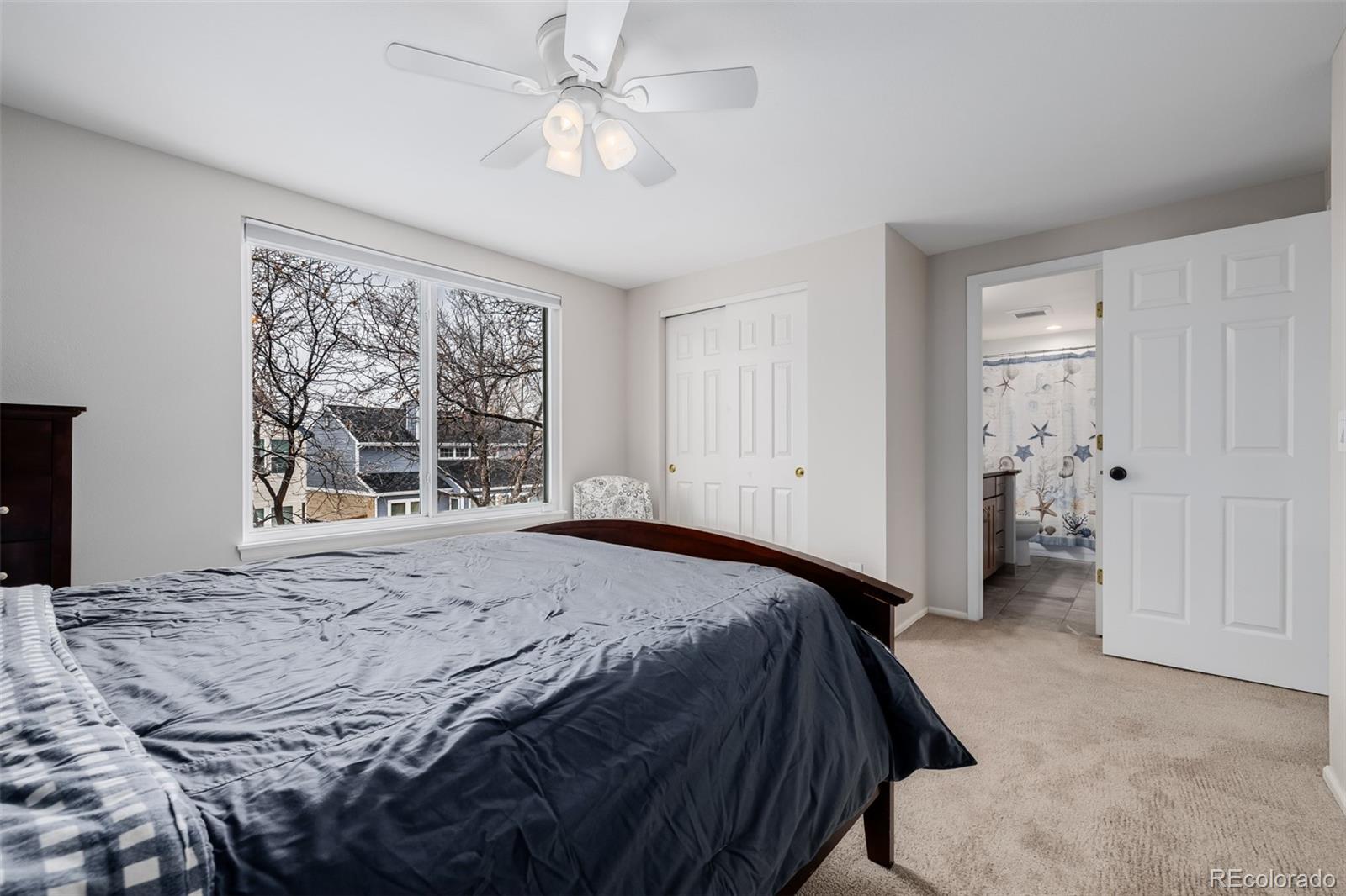 8827 South Cactus Flower Way Highlands Ranch, CO 80126 - Photo 33 of 49 a bedroom with a large bed and a window
