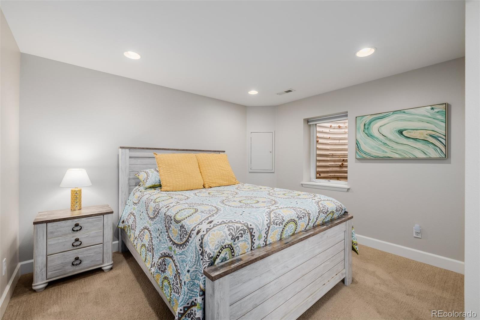 8827 South Cactus Flower Way Highlands Ranch, CO 80126 - Photo 37 of 49 a bedroom with a bed and a lamp