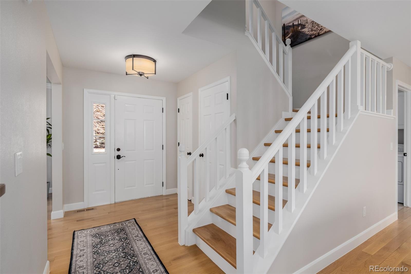 8827 South Cactus Flower Way Highlands Ranch, CO 80126 - Photo 4 of 49 a view of an entryway with wooden floor