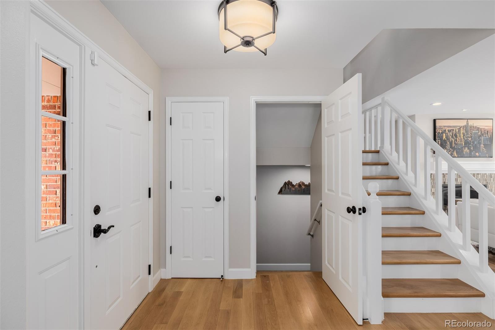 8827 South Cactus Flower Way Highlands Ranch, CO 80126 - Photo 5 of 49 a view of a hallway with wooden floor and entryway