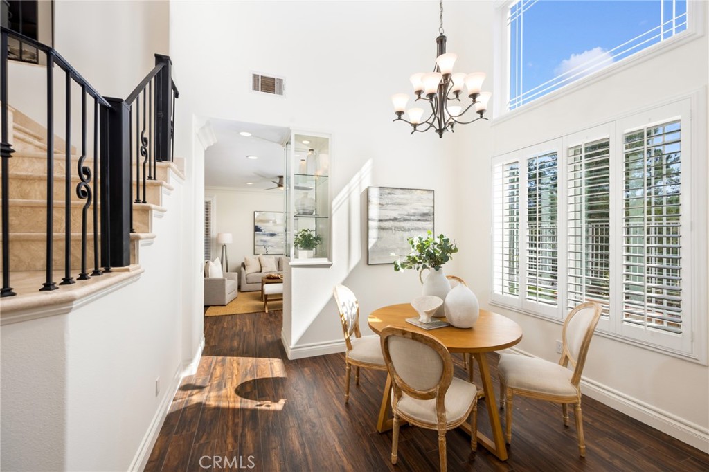 29 Beaulieu Lane Lake Forest, CA 92610 - Photo 12 of 60 a dining room with furniture a chandelier and wooden floor