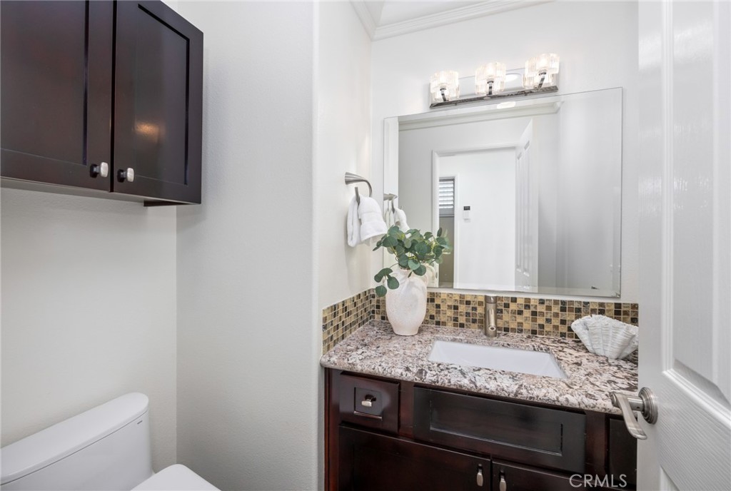 29 Beaulieu Lane Lake Forest, CA 92610 - Photo 24 of 60 a bathroom with a granite countertop sink and a mirror