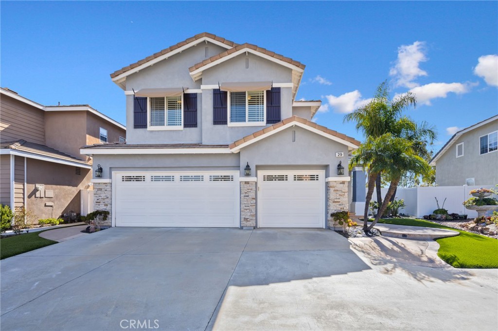 29 Beaulieu Lane Lake Forest, CA 92610 - Photo 3 of 60 a view of a house with a yard and garage